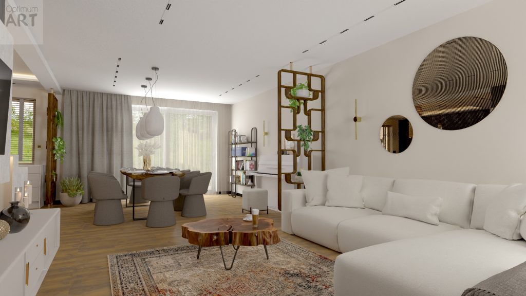 Nowoczesny salon z białą sofą narożną, drewnianym stolikiem kawowym i okrągłymi dekoracjami na ścianie. W tle widać jadalnię ze stołem i krzesłami oraz regał z roślinami, całość utrzymana w jasnej kolorystyce z drewnianymi akcentami.