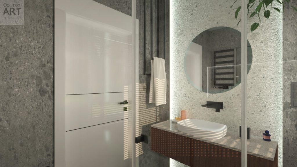 Nowoczesna łazienka z okrągłym lustrem, białą umywalką na drewnianej szafce i szarymi kafelkami na ścianach. Po lewej stronie znajdują się białe drzwi, a na ścianie wisi grzejnik łazienkowy.